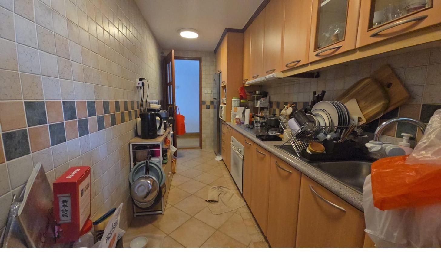 Kitchen with wooden cabinets before PropEdit enhancement — dim lighting and clutter